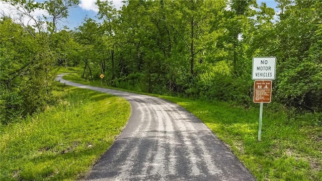 view of road with a forest view
