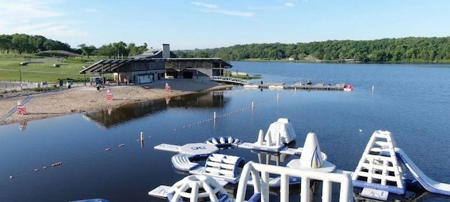 view of dock featuring a view of trees and a water view