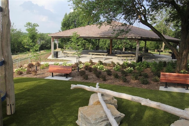 surrounding community with a gazebo, a lawn, and fence