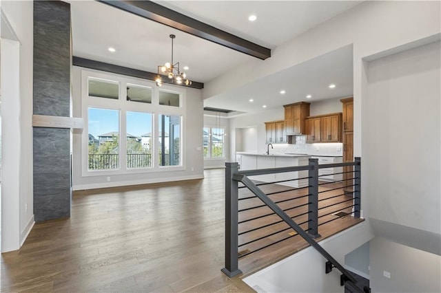 11606 S Zarda Dr, Olathe, KS 66061 - stairs with recessed lighting, beam ceiling, a notable chandelier, baseboards, and wood finished floors