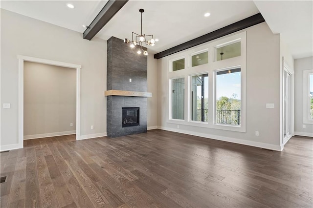 11606 S Zarda Dr, Olathe, KS 66061 - unfurnished living room with a chandelier, baseboards, dark wood-style flooring, and a fireplace