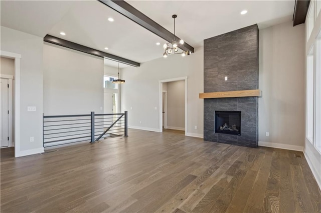 11606 S Zarda Dr, Olathe, KS 66061 - unfurnished living room with beamed ceiling, an inviting chandelier, a tile fireplace, recessed lighting, and wood finished floors