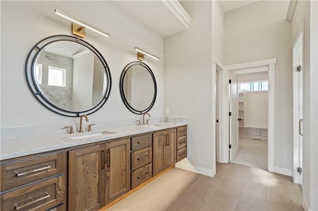 11606 S Zarda Dr, Olathe, KS 66061 - bathroom with tile patterned floors, plenty of natural light, double vanity, and a sink