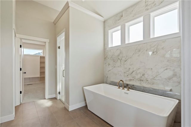 11606 S Zarda Dr, Olathe, KS 66061 - full bathroom featuring tile patterned flooring, a freestanding bath, a shower stall, and baseboards