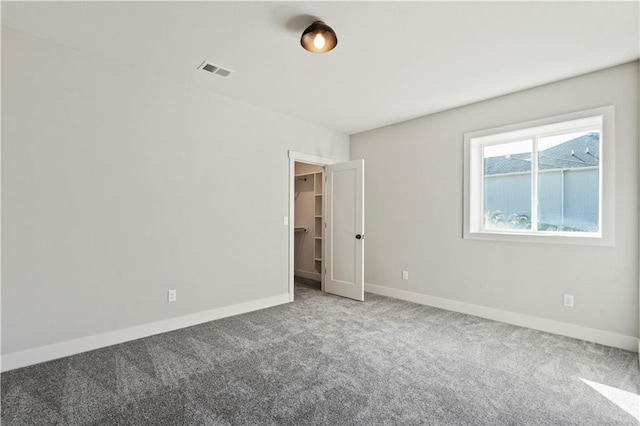 11606 S Zarda Dr, Olathe, KS 66061 - unfurnished bedroom featuring visible vents, a spacious closet, baseboards, and carpet floors
