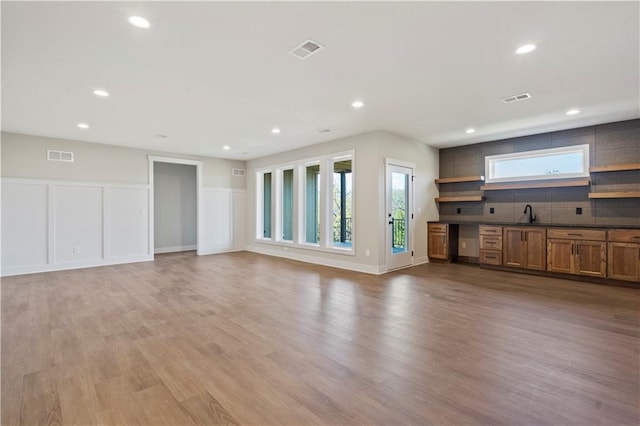11606 S Zarda Dr, Olathe, KS 66061 - unfurnished living room featuring light wood finished floors and visible vents