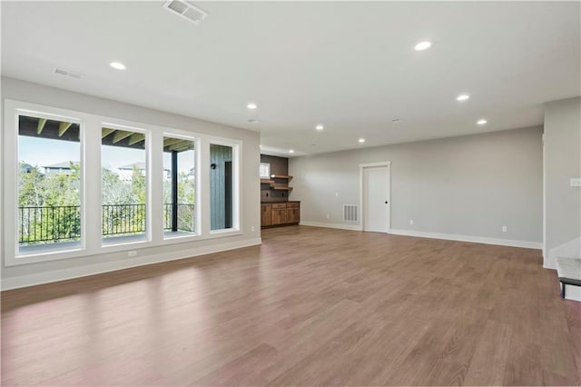 11606 S Zarda Dr, Olathe, KS 66061 - unfurnished living room featuring visible vents, recessed lighting, and light wood-type flooring