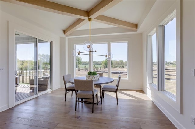 sunroom / solarium featuring a notable chandelier and beamed ceiling