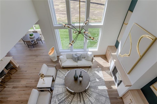 living room with light hardwood / wood-style flooring and a high ceiling