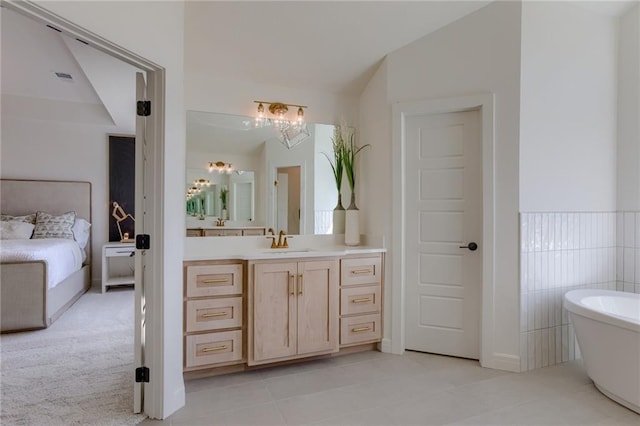 bathroom featuring tile flooring, a bathing tub, and vanity