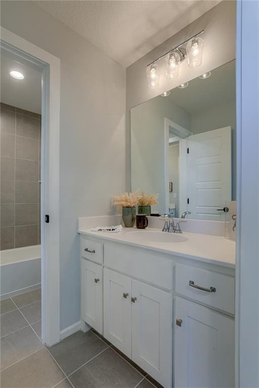 bathroom featuring tile flooring, vanity, and shower / bath combination