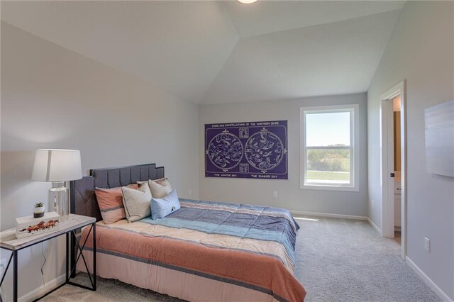 carpeted bedroom with vaulted ceiling