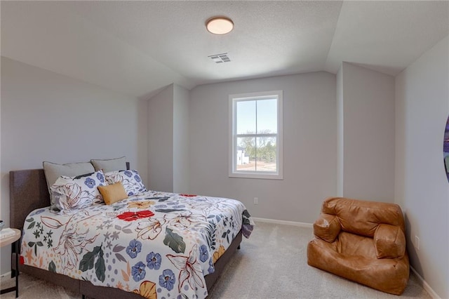 bedroom featuring light colored carpet and vaulted ceiling