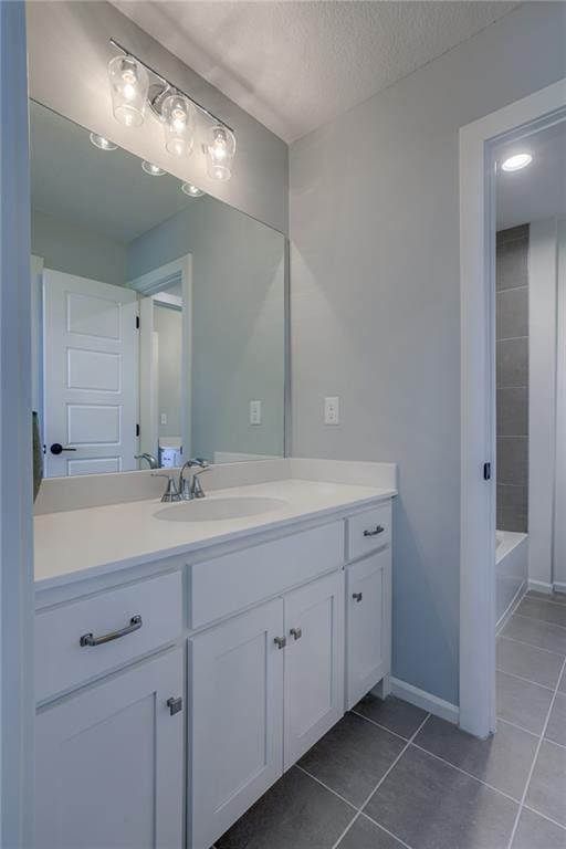 bathroom with tub / shower combination, tile floors, vanity, and a textured ceiling