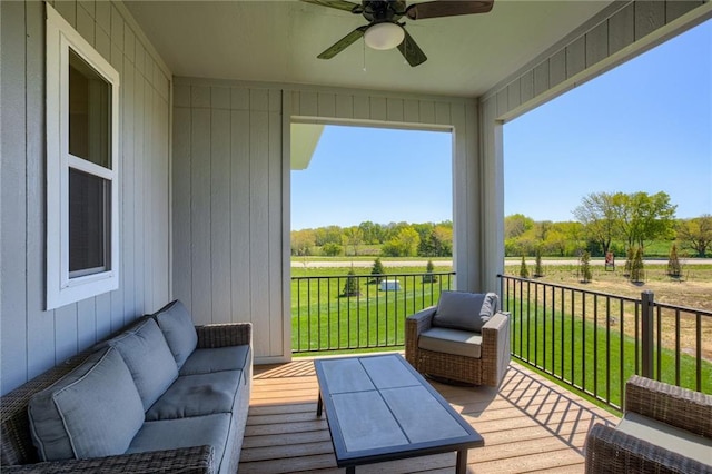 deck with an outdoor living space, a yard, and ceiling fan