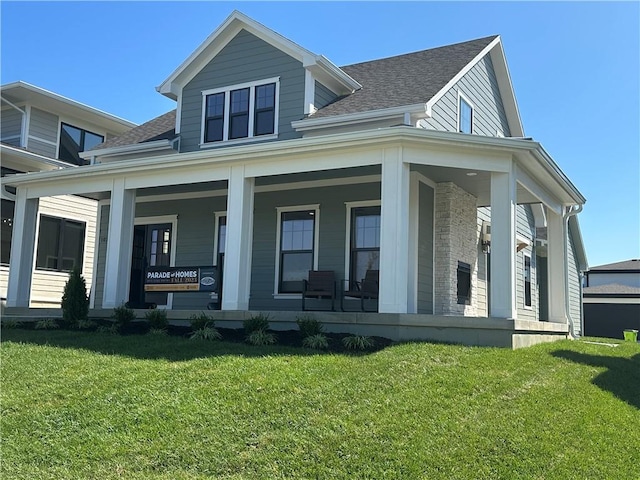 exterior space featuring covered porch and a yard