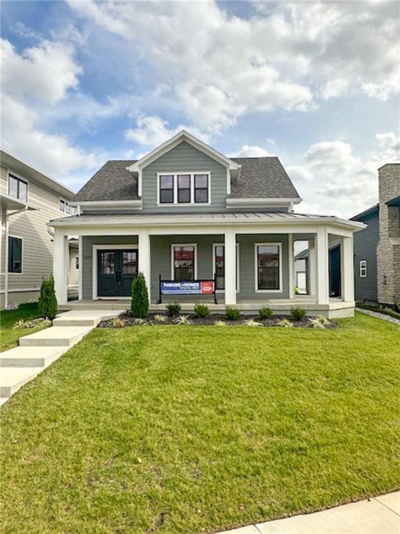 view of front of house with a front yard and a porch