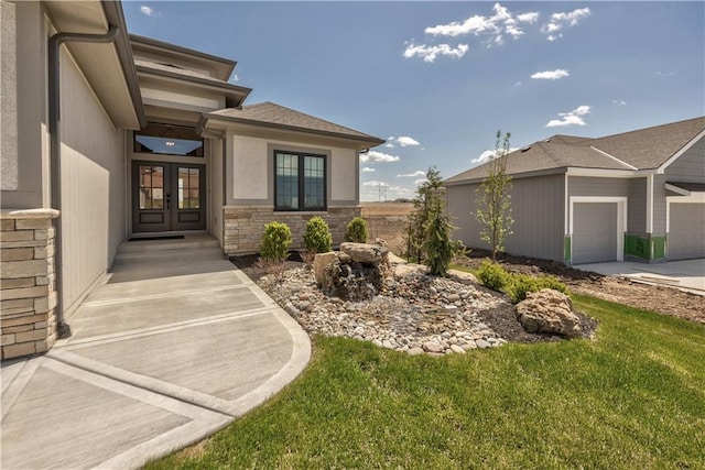 exterior space featuring a yard, french doors, and a garage