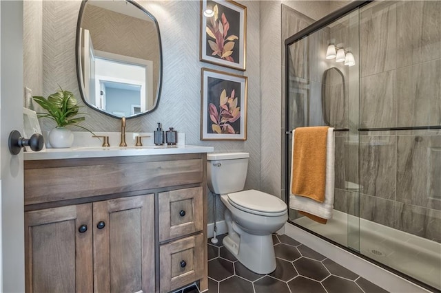 bathroom with toilet, tile floors, a shower with shower door, and vanity