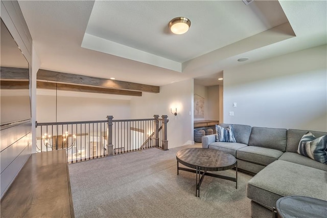 living room featuring a raised ceiling, beam ceiling, and wood-type flooring