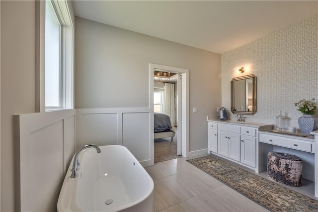 bathroom featuring a chandelier, a bath, tile floors, and large vanity