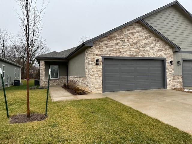 view of front of property with a garage and a front yard