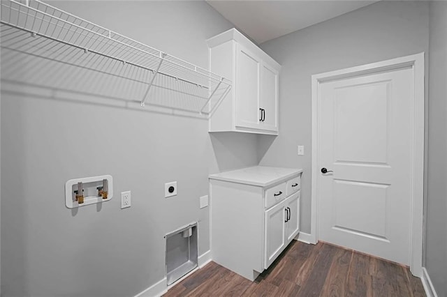 washroom featuring washer hookup, electric dryer hookup, cabinets, and dark wood-type flooring