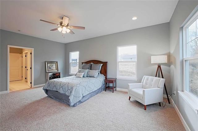 carpeted bedroom with multiple windows and ceiling fan