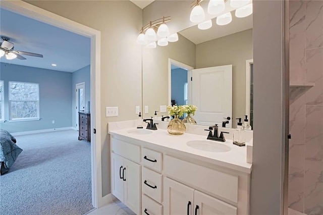 bathroom featuring oversized vanity, dual sinks, and ceiling fan