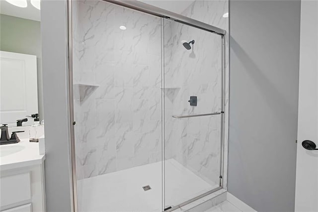 bathroom with a shower with shower door, tile flooring, and oversized vanity