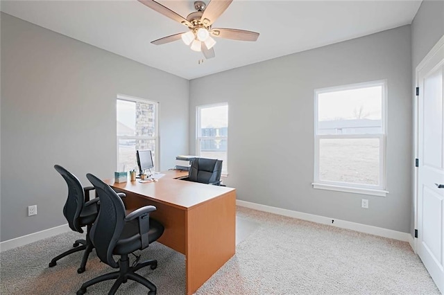 carpeted home office with ceiling fan