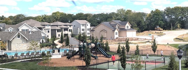 exterior space featuring tennis court, a swimming pool, and a playground