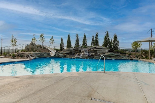 view of pool with a patio and a water slide