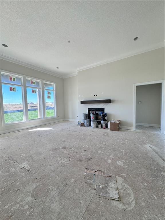 unfurnished living room featuring crown molding and a textured ceiling