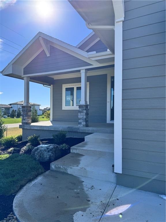 view of exterior entry with covered porch