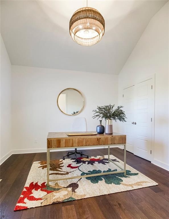 home office featuring high vaulted ceiling and dark hardwood / wood-style flooring