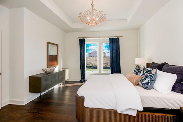 bedroom featuring a raised ceiling, crown molding, a chandelier, and dark hardwood / wood-style flooring