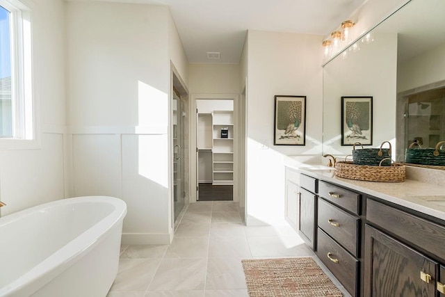 bathroom with shower with separate bathtub, tile patterned floors, and vanity