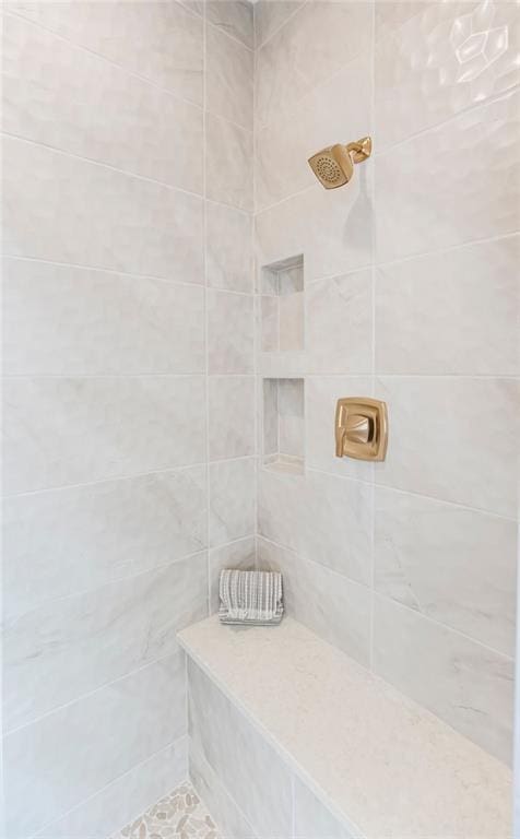 bathroom with tiled shower