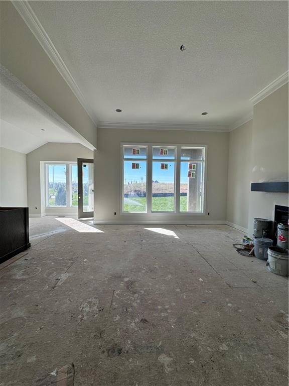 unfurnished living room featuring a textured ceiling, plenty of natural light, and ornamental molding