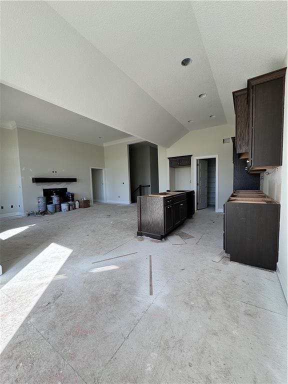 kitchen with dark brown cabinets, a textured ceiling, and lofted ceiling