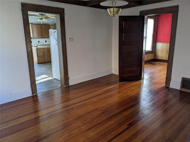 unfurnished room featuring ceiling fan and dark wood-type flooring