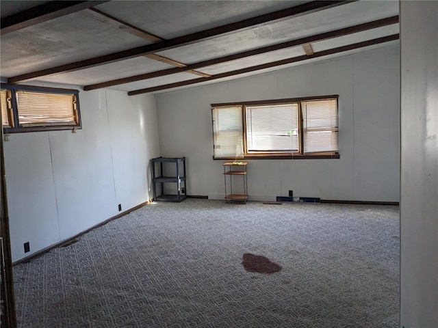 unfurnished room featuring light carpet and vaulted ceiling with beams