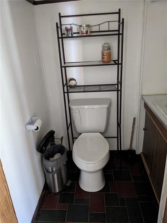 bathroom with vanity, tile floors, and toilet