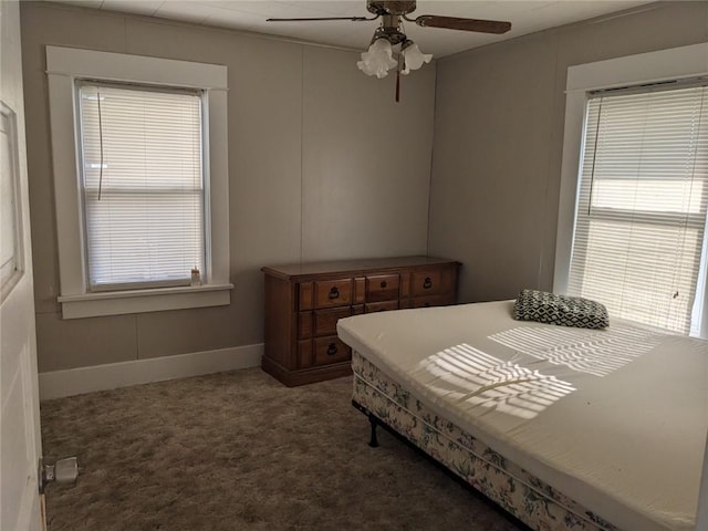 bedroom with dark colored carpet and ceiling fan