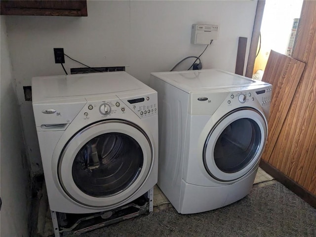 laundry area featuring separate washer and dryer, electric dryer hookup, and light tile floors