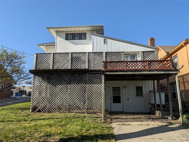 view of front of house with a balcony and a front yard