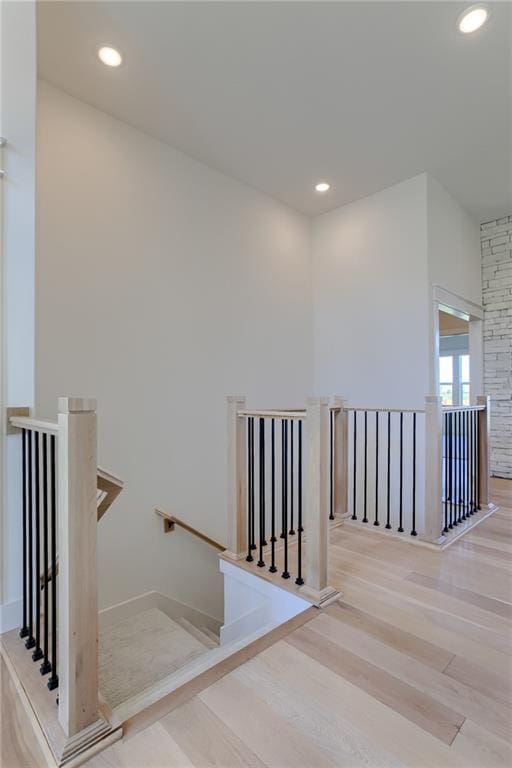 stairway with hardwood / wood-style floors