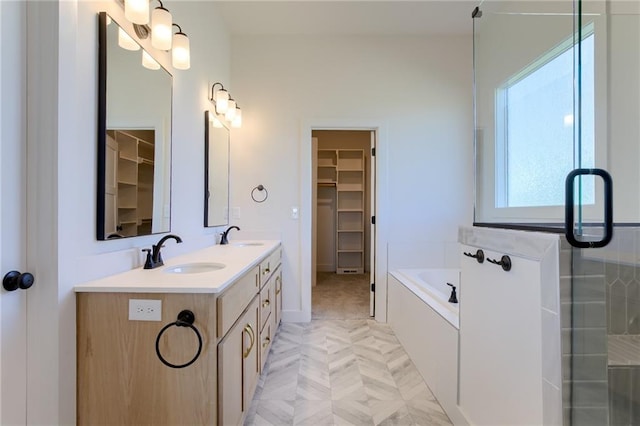 bathroom with vanity and shower with separate bathtub