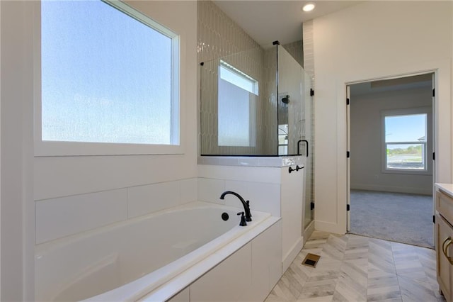 bathroom with tile patterned flooring, vanity, and independent shower and bath